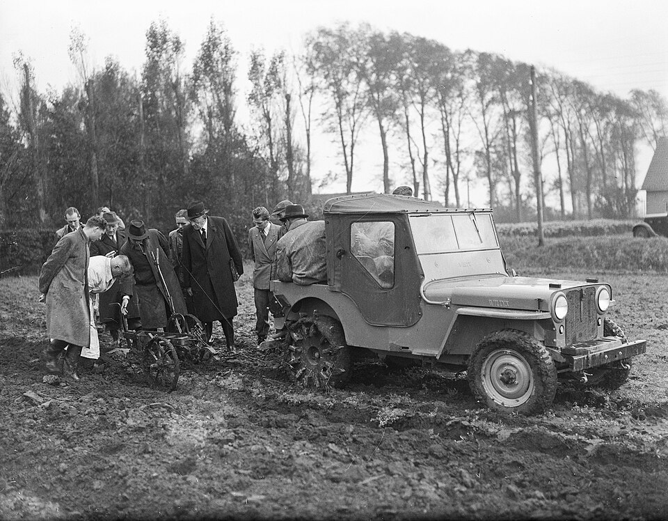 Archive photo of a civilian Jeep at work in a field in 1946